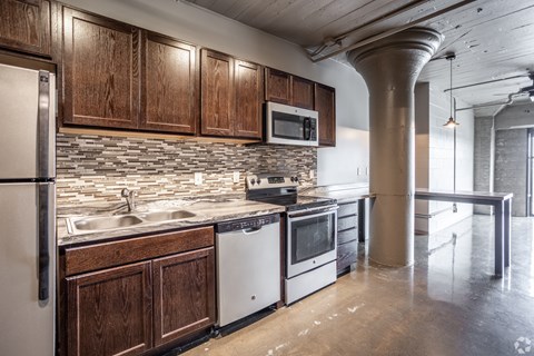 A kitchen with wooden cabinets and stainless steel appliances.
