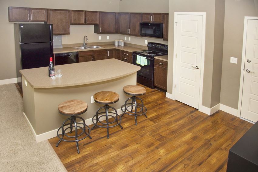 Large open kitchen with dark cabinets at The Sterling Kearney in Kearney, NE