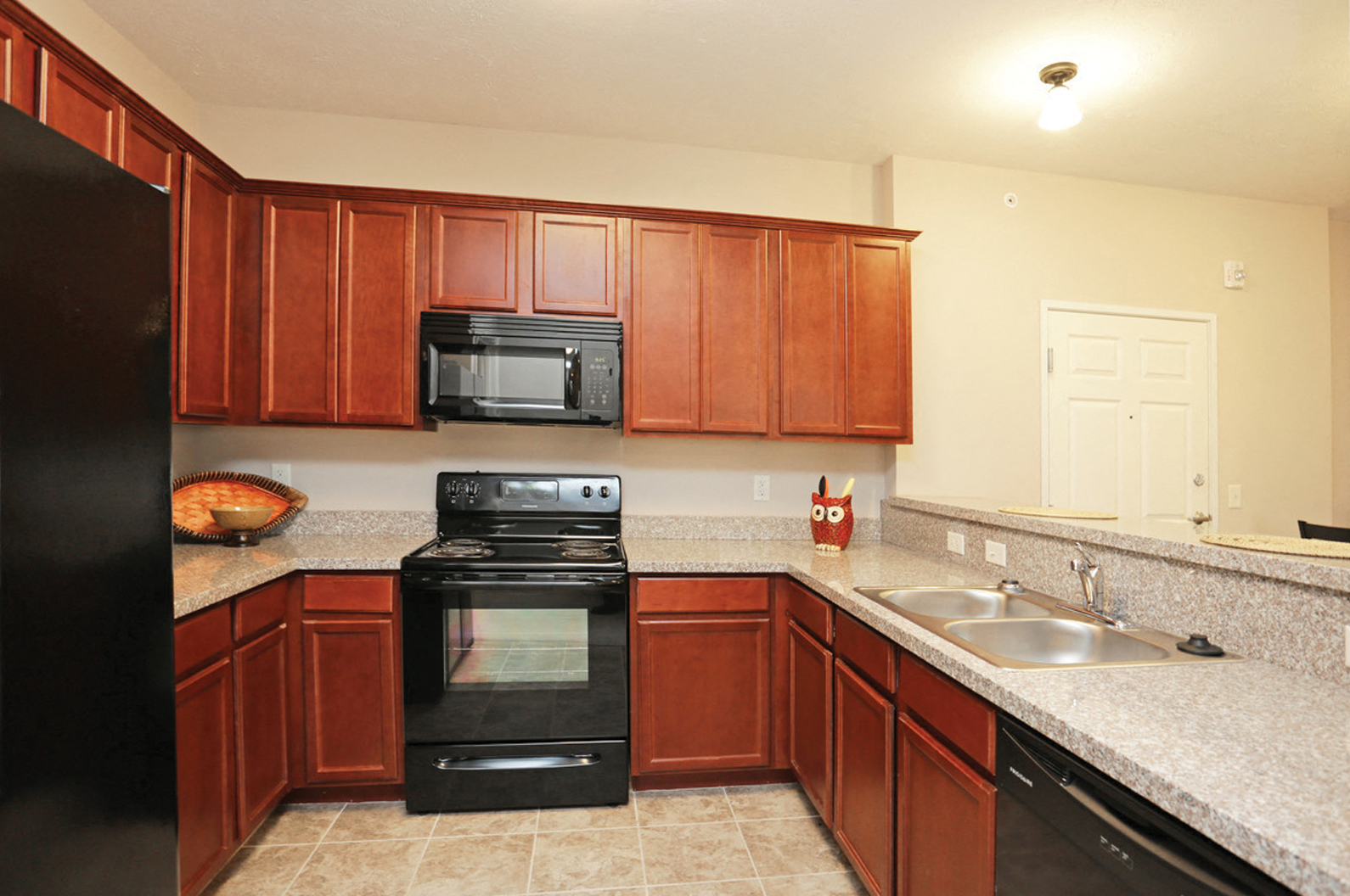 a kitchen with black appliances and granite counter tops