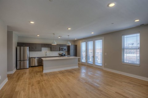 A kitchen with wooden floors and stainless steel appliances.