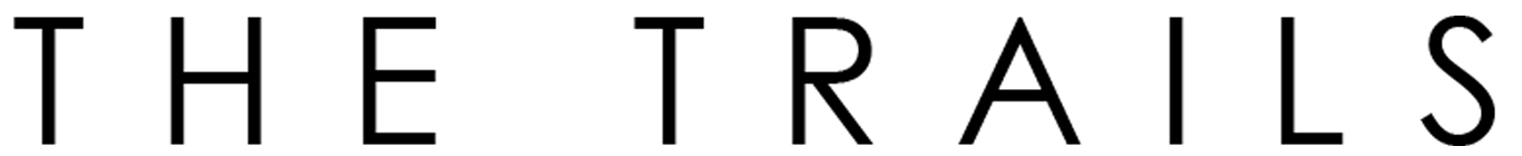 The image displays the words "THE TRAILS" in large, bold letters.