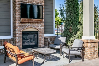 Poolside fireplace and seating area at Legacy Commons Apartments in Omaha, NE - Photo Gallery 3