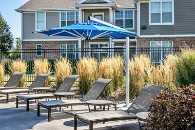 Poolside lounge area at Legacy Commons Apartments in Omaha, NE - Photo Gallery 5