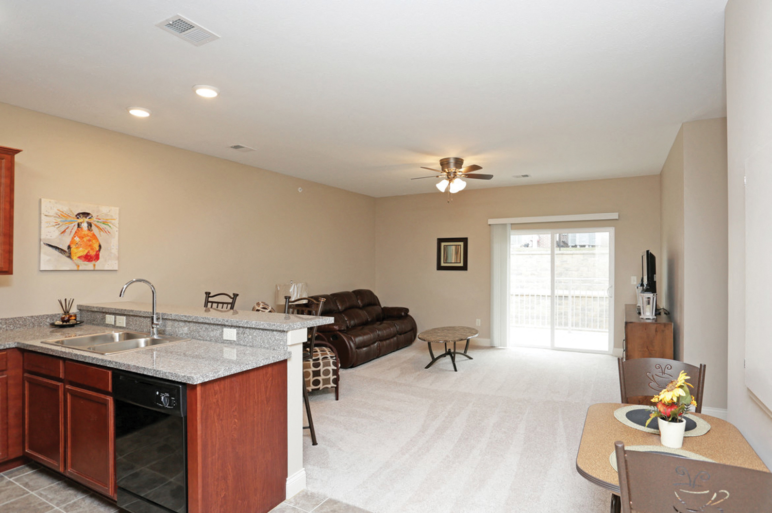 a kitchen and living room with a couch and a table