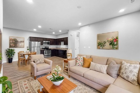 A living room with a couch, chairs, and a coffee table.