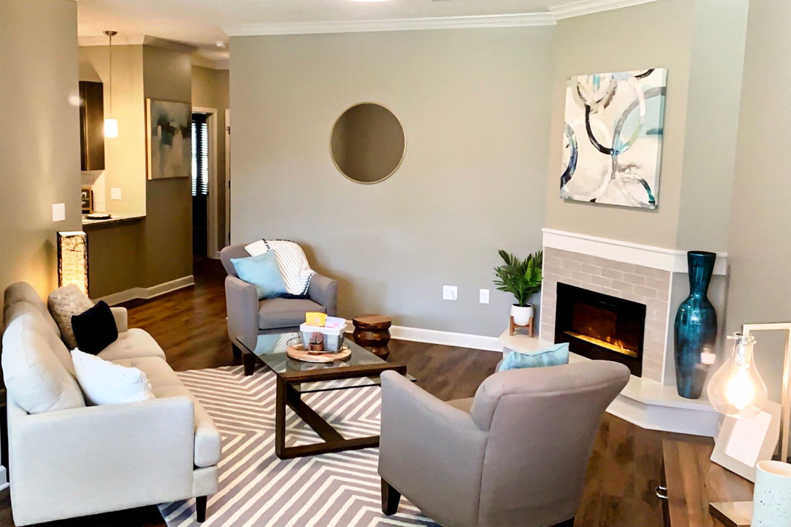 a living room with couches and chairs and a fireplace