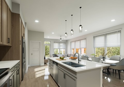A modern kitchen with a large island and pendant lights.