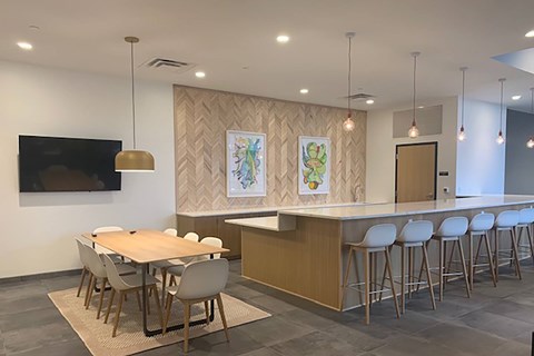 A modern dining room with a wooden table and chairs.