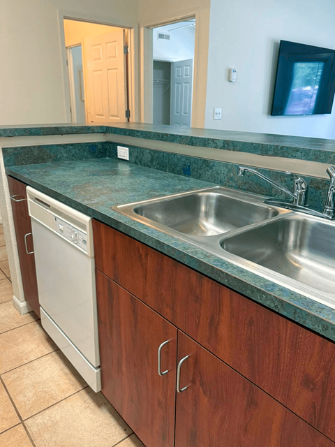 A kitchen with a washer and dryer built in.