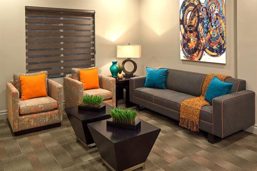 a living room with couches and chairs and tables