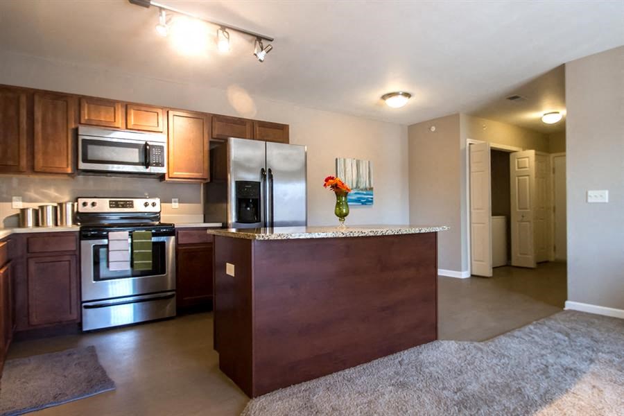 a kitchen with stainless steel appliances and a counter top