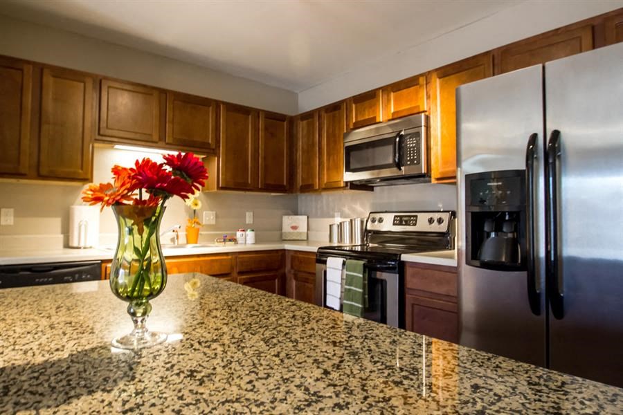 a kitchen with stainless steel appliances and a granite counter top