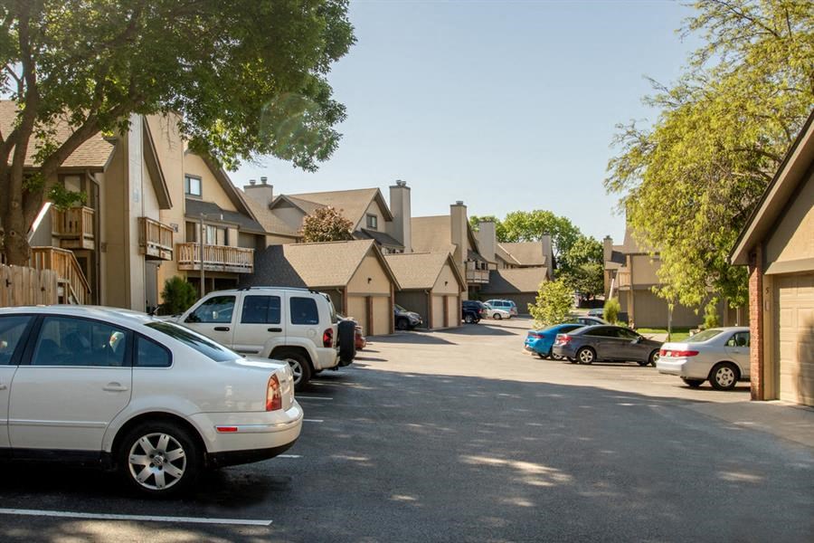 a street with cars parked in front of houses