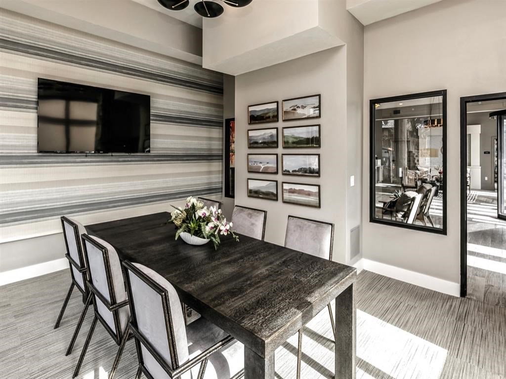 a dining room with a table and chairs