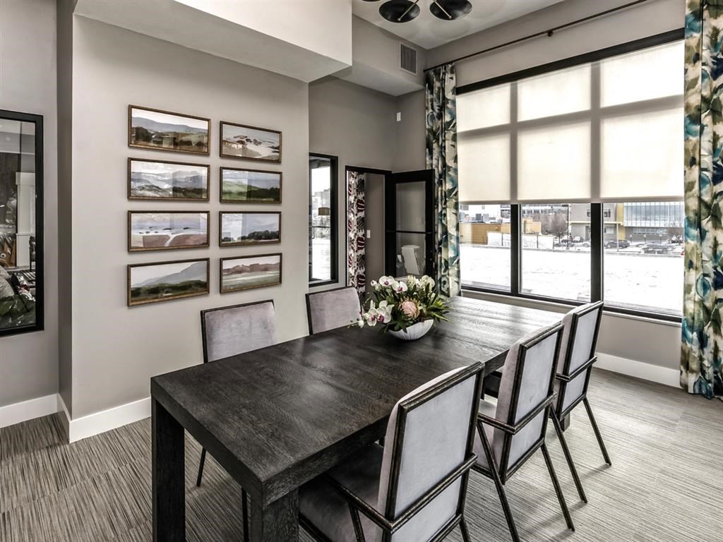 a dining room with a wooden table and chairs