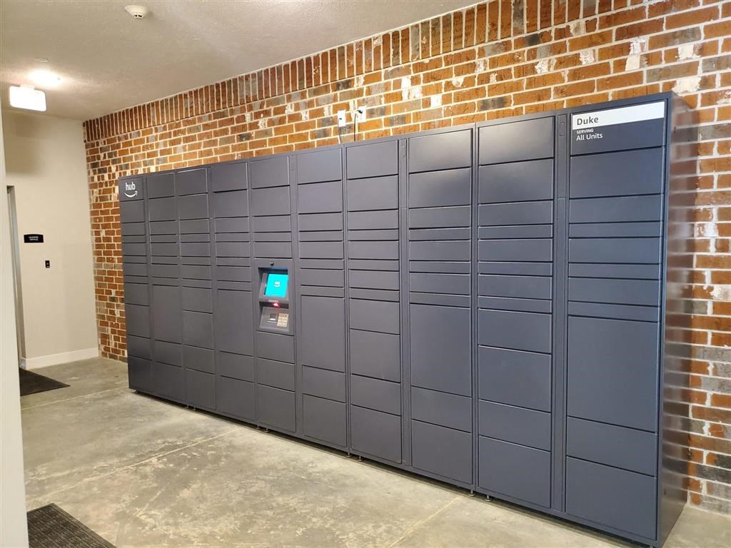 a set of lockers in front of a brick wall