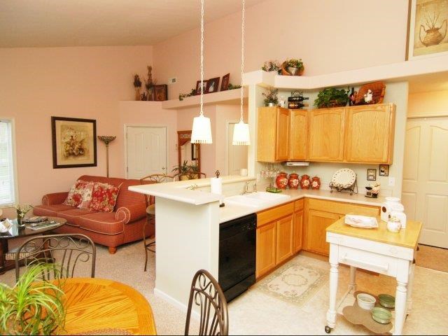 a kitchen and living room with a table and chairs