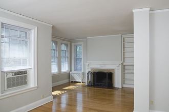 a living room with a fireplace and a wooden floor