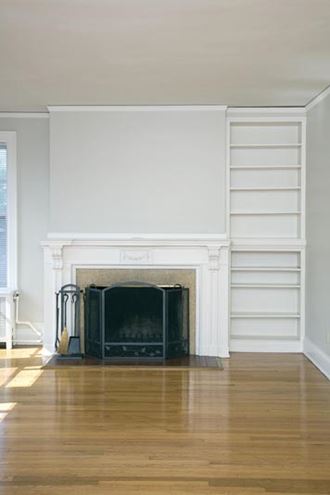 a living room with a fireplace and a wooden floor