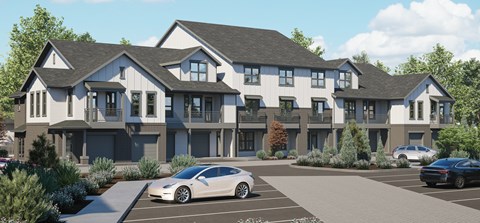 A modern two-story building with a parking lot in front.