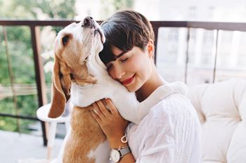 a girl hugging her dog