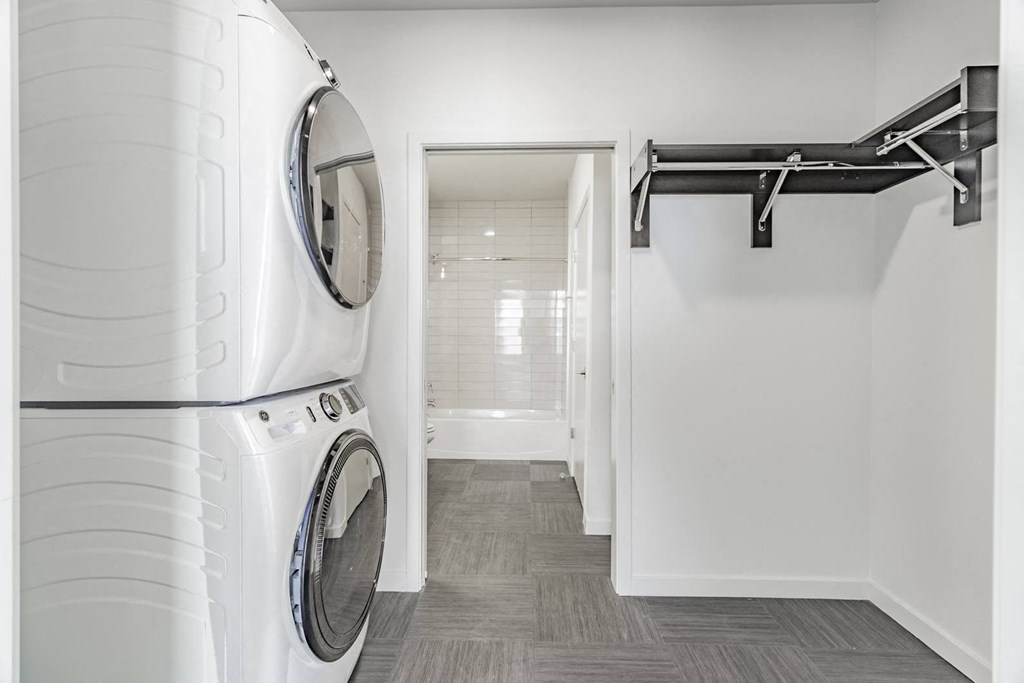 Stacked in-unit washer and dryers in each apartment home at Pinnacle Heights Apartments in Rogers, Arkansas.