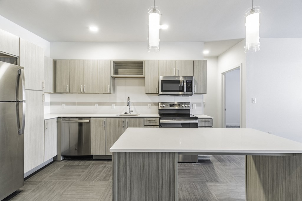 One and two Bedroom Apartment Homes with Large Kitchens with ample storage and light cabinets at Pinnacle Heights Apartments in Rogers, Arkansas