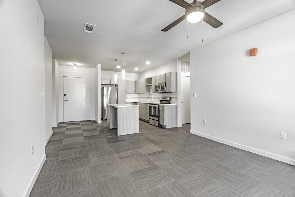 One and two Bedroom Apartment Homes with Large Kitchens with ample storage and light cabinets, quarts countertops and stainless steel appliances at Pinnacle Heights Apartments in Rogers, Arkansas