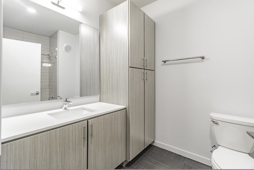Bathrooms featuring quartz countertops extra storage and space at Pinnacle Heights Apartments at Rogers, Arkansas.