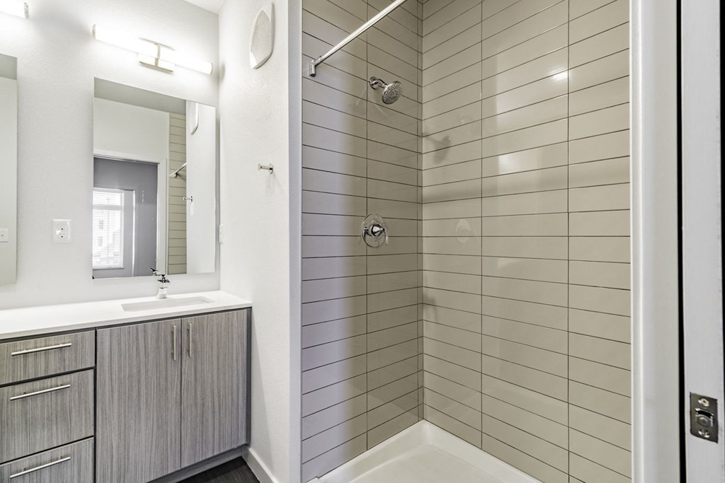 Bathrooms featuring quartz countertops extra storage and space at Pinnacle Heights Apartments at Rogers, Arkansas.