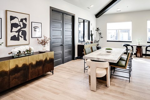 a dining room with a table and chairs and a large door