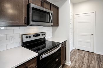 One, two and three-bedroom floor plans featuring two interior design schemes, quartz countertops, tile backsplash, stainless steel appliances, backlit mirrors, high-end finishes and more at 148 Place Apartments in Omaha, NE