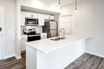 One, two and three-bedroom floor plans featuring two interior design schemes, quartz countertops, tile backsplash, stainless steel appliances, backlit mirrors, high-end finishes and more at 148 Place Apartments in Omaha, NE
