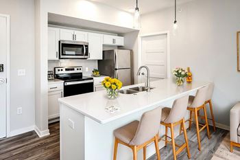 One, two and three-bedroom floor plans featuring two interior design schemes, quartz countertops, tile backsplash, stainless steel appliances, backlit mirrors, high-end finishes and more at 148 Place Apartments in Omaha, NE