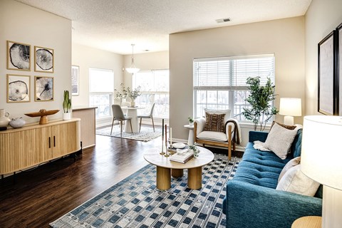 A living room with a blue couch and a coffee table.