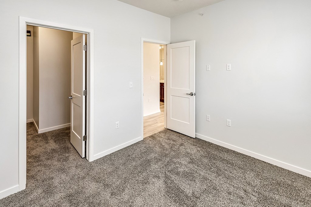 Bedroom with a carpeted flooring at Belle Point in Bellevue, NE