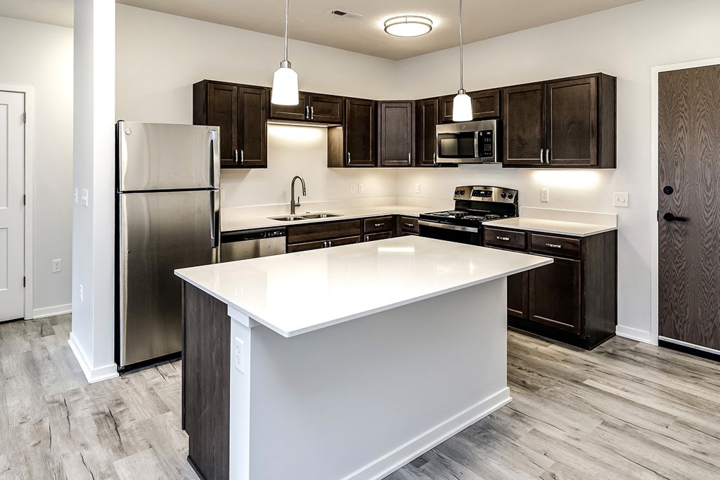 Kitchen with an island and stainless steel appliances at Belle Point in Bellevue, NE