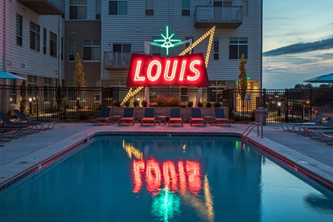 A pool with the word Louis spelled out in the water.
