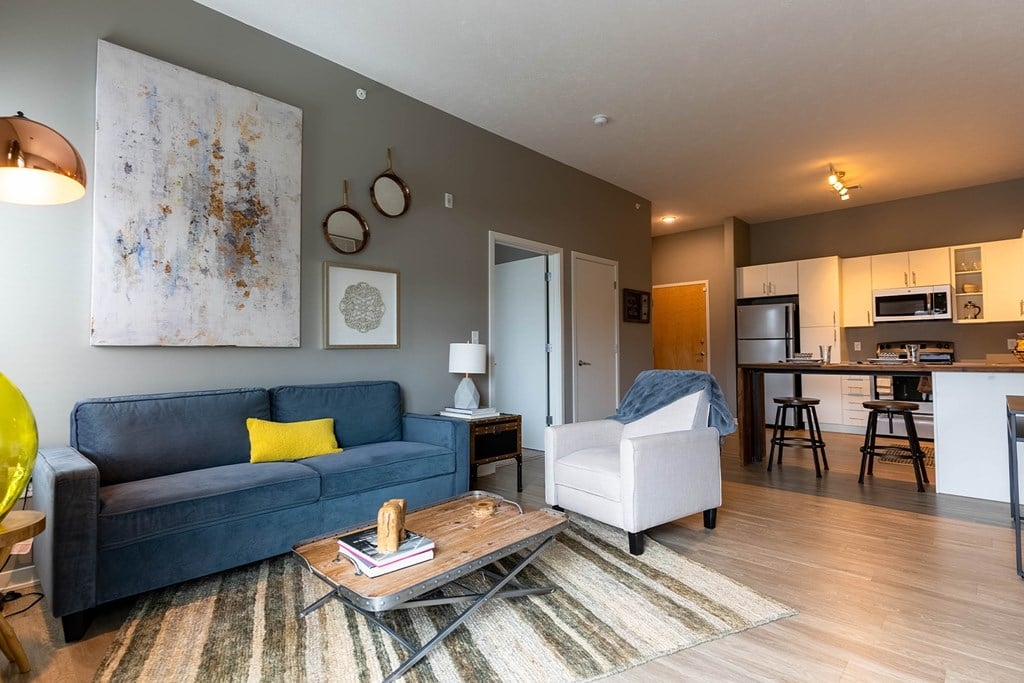 Studio, one, and two-bedroom apartment featuring stainless steel appliances, artistic industrial design, custom butcher block island, in-unit washer and dryer, and more at Benson Lights Apartments in Benson, NE
