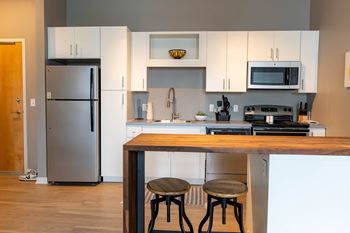Chef-Inspired Kitchens with White or Java Cabinets at Benson Lights Apartments in Benson, NE