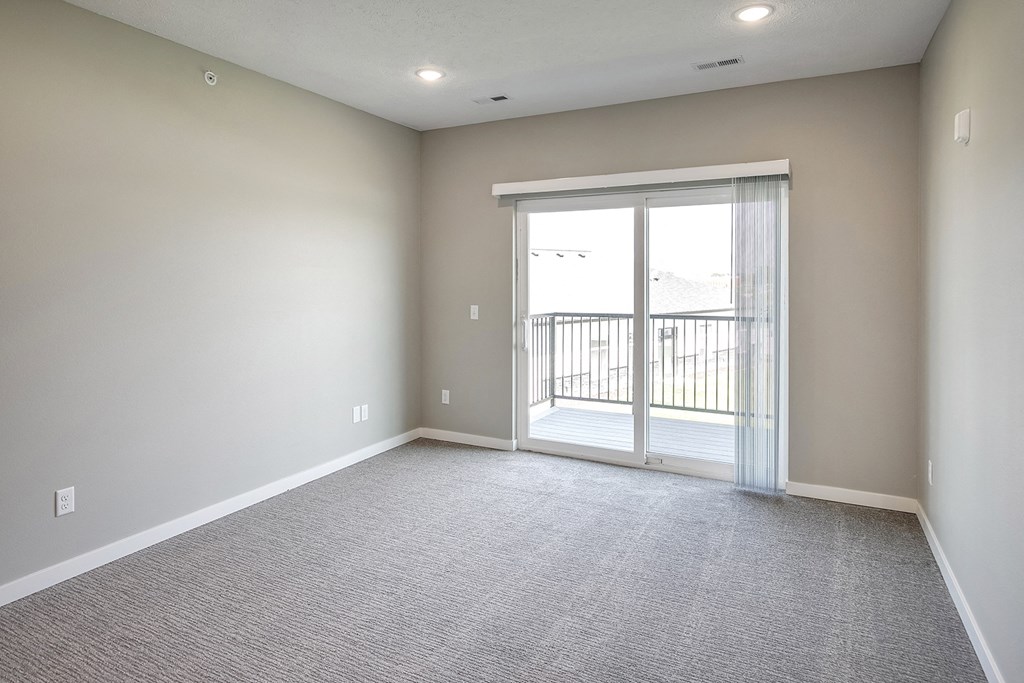Living room with balcony at Cross Creek in Lexington, NE
