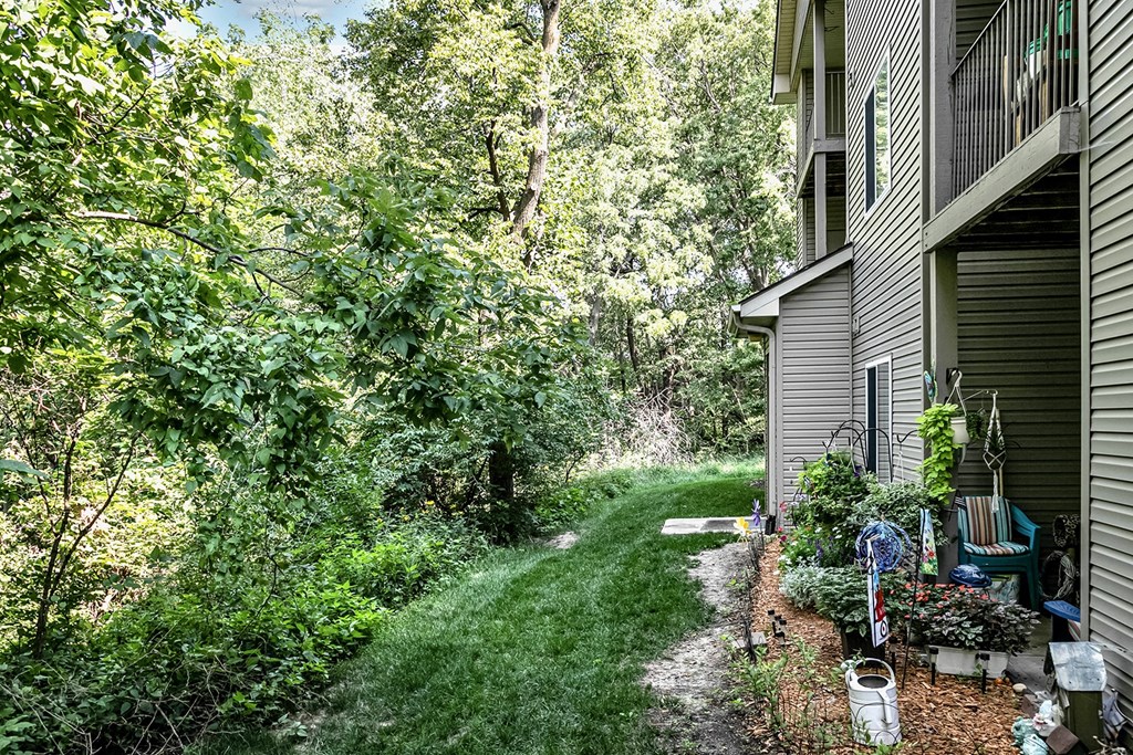 Patio Back Patio with lush greenery at Deer Park Apartments in Council Bluffs, IA