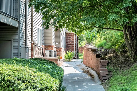 Beautiful walkway with plants  at Deer Park Apartments in Council Bluffs, IA