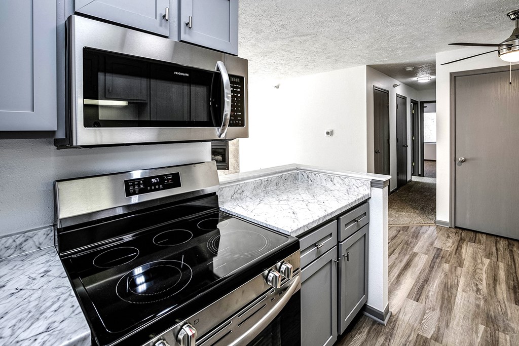Kitchen with stainless steel appliances  at Deer Park Apartments in Council Bluffs, IA