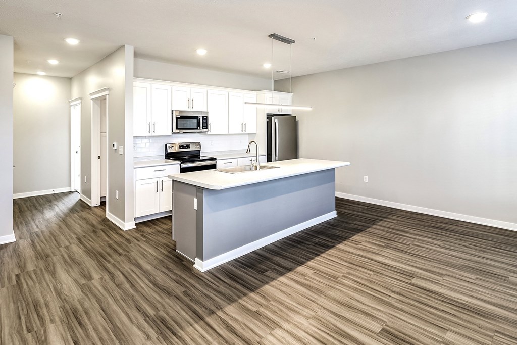 an empty kitchen with a large counter top in the middle