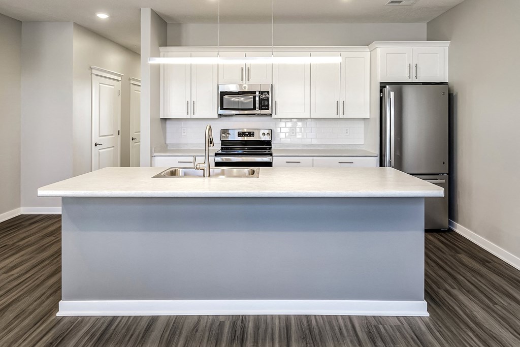 a kitchen with white cabinets and a white counter top