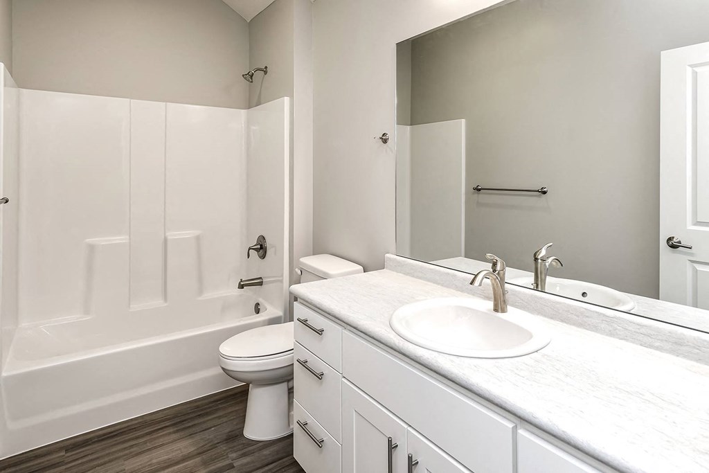 a white bathroom with a sink and a toilet