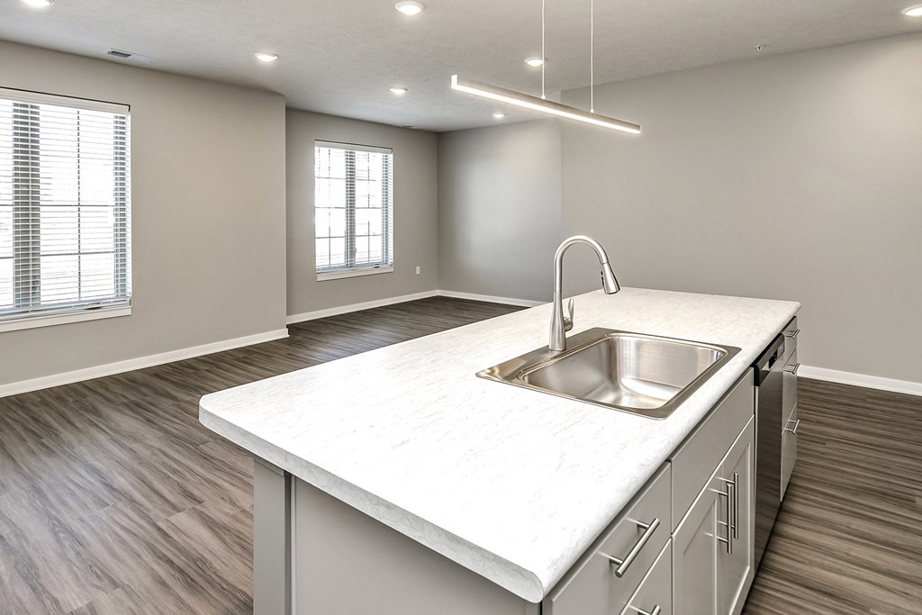 an empty kitchen with a sink and a window
