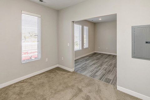 the spacious living room and dining room in a new home