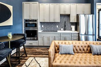 Resident Lounge with Fireplace, Bar, and Kitchen Area at The Fireside at Waukee in Waukee, IA